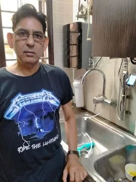 Man quenching thirst with water from the Chanson Quality Purifier
