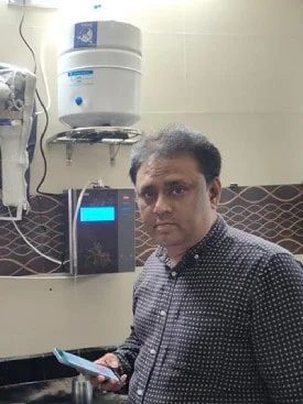 Male enjoying clean water from the Chanson Quality Water Purifier