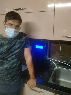 Man at home with his Chanson Quality Water Purifier