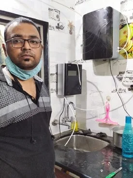 Man using Chanson Quality Water Purifier in the kitchen