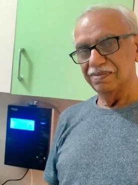 Man ensuring his water is clean with the Chanson Quality Purifier