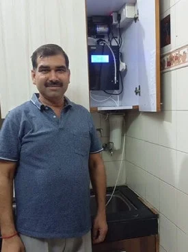 Male demonstrating ease of use of the Chanson Water Purifier